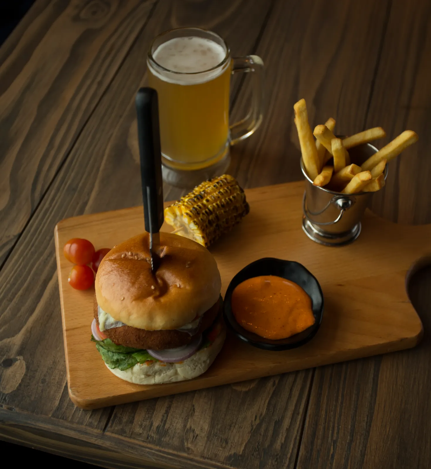 A burger served on a wooden board.